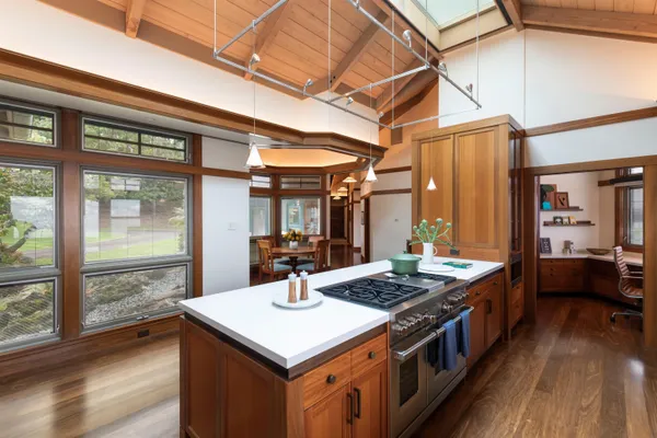 a kitchen with a stove and wooden floor