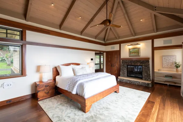 a bedroom with a bed and a fireplace