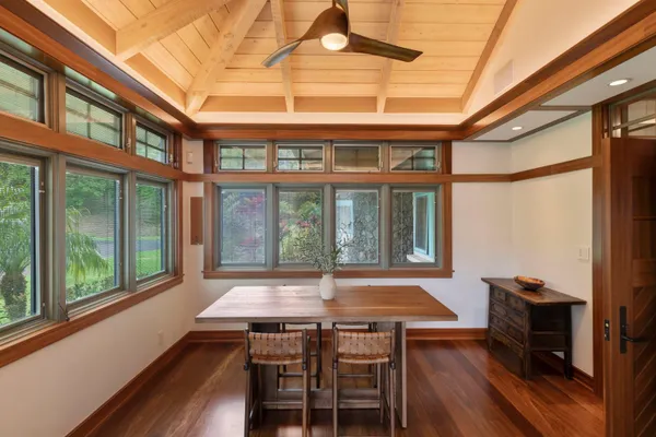 a view of an entryway with wooden floor and livingroom