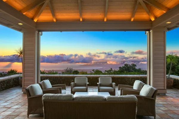 a view of a patio with couches chairs and a potted plant