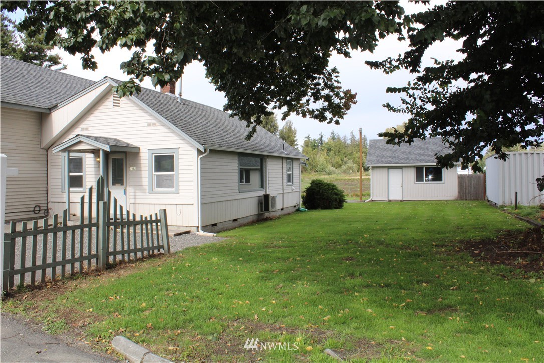 2882 East Badger Road Everson, WA 98247 - Photo 3 of 40 a view of a yard in front of a house with plants and large tree