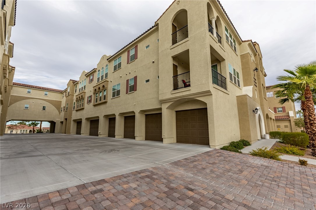 2555 Hampton Road, Unit 8206 Henderson, NV 89052 - Photo 35 of 35 This multi-story property showcases Mediterranean-inspired architecture with integrated garage access and a charming walkway.