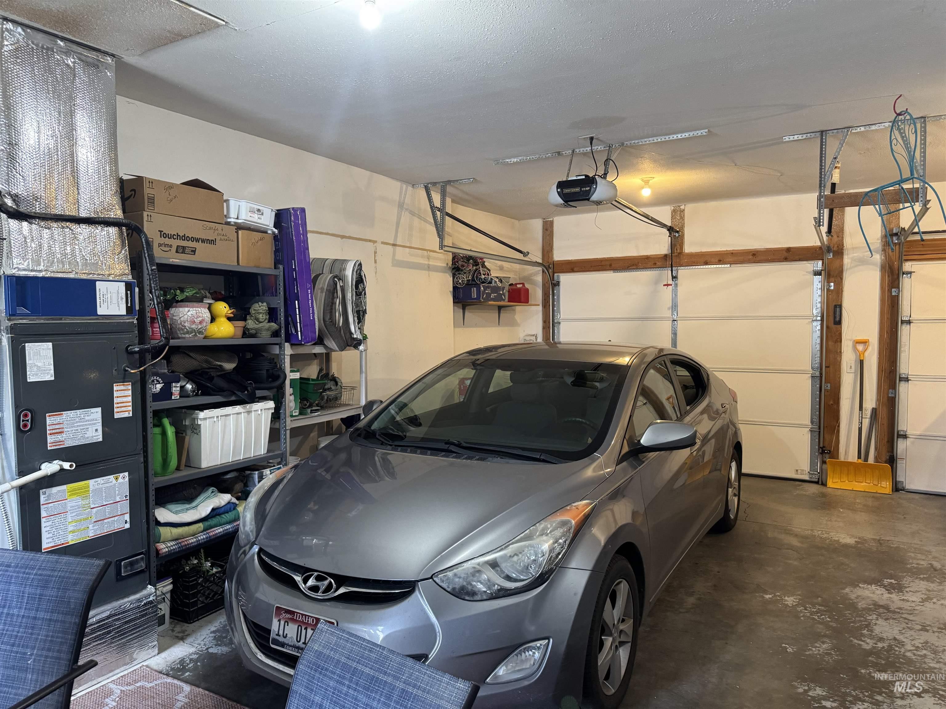 1145 Utah Street Gooding, ID 83330 - Photo 33 of 50 Garage with heating unit and a garage door opener