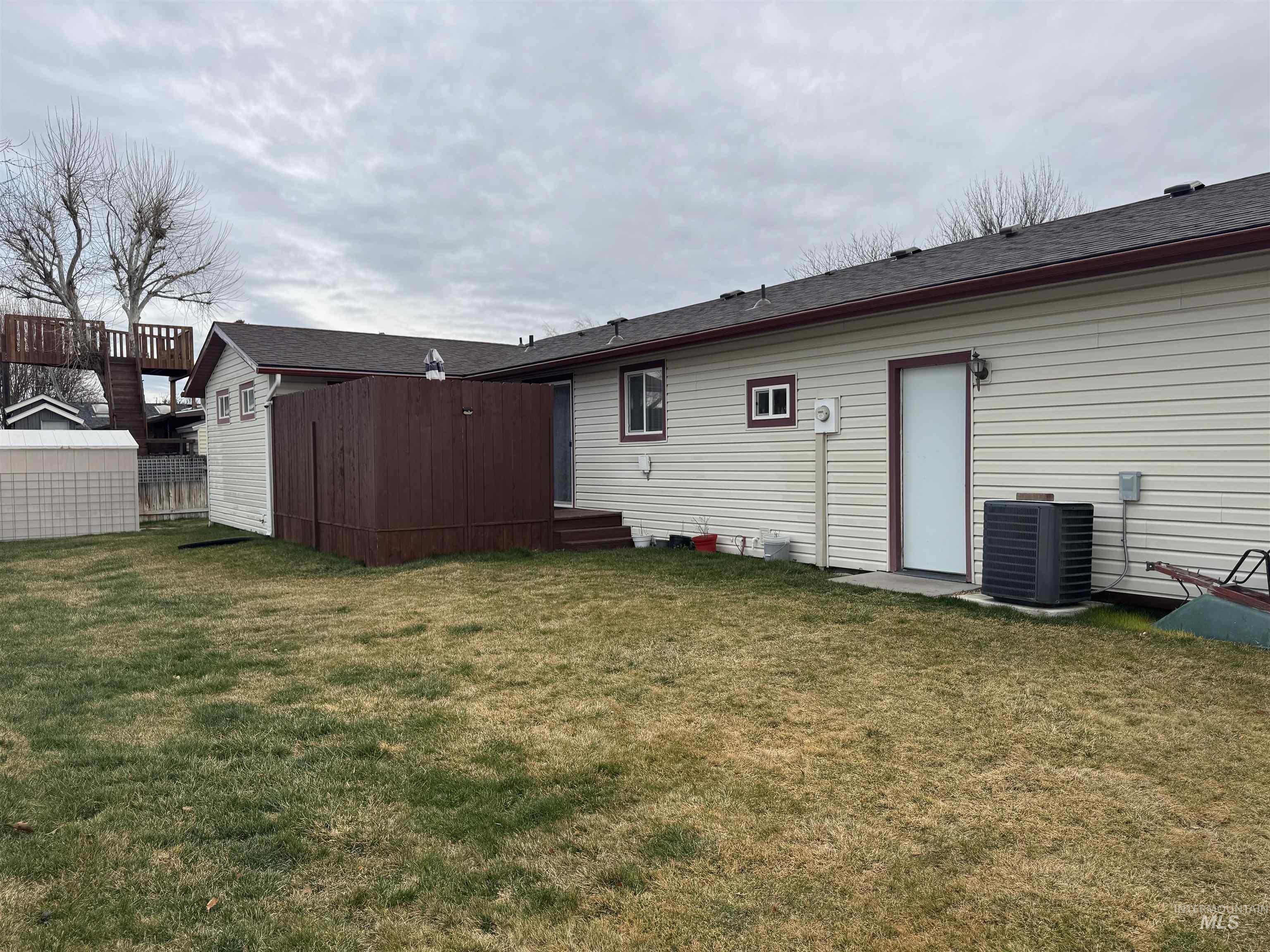 1145 Utah Street Gooding, ID 83330 - Photo 41 of 50 Rear view of house with a lawn, a wooden deck, and an outdoor structure