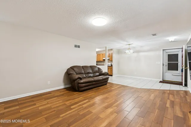 a living room with a couch and a wooden floor