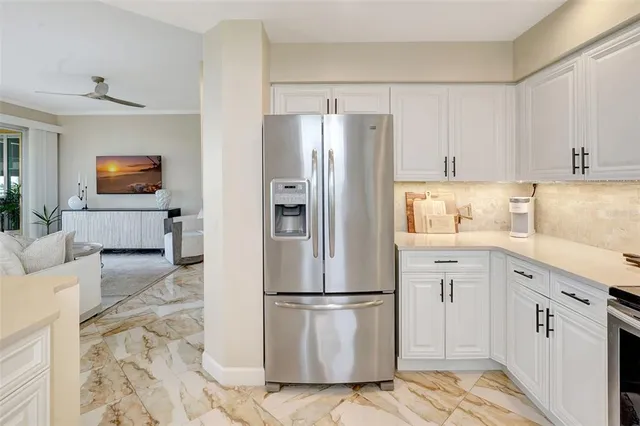 a kitchen with a refrigerator sink and cabinets