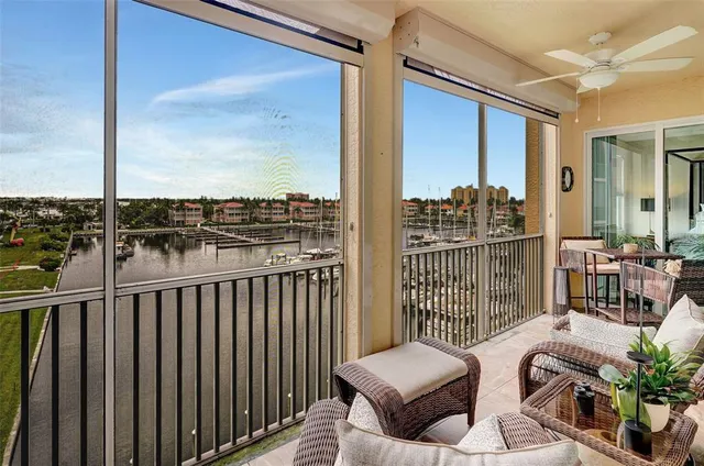 a balcony with furniture and a floor to ceiling window