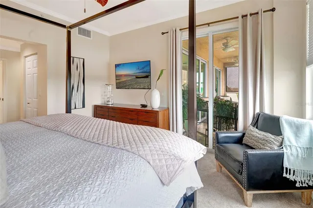 a bedroom with a bed couch and a window