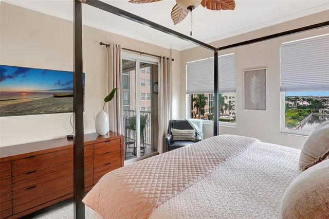 a bedroom with a bed and a dresser with mirror