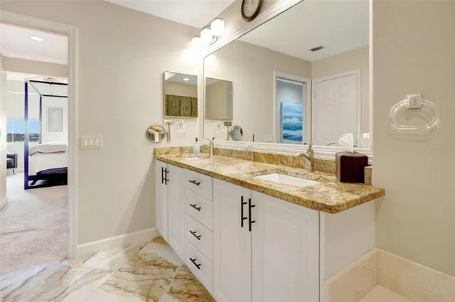 a bathroom with a sink double vanity and a mirror