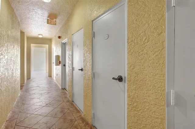 a view of a hallway with a bathroom