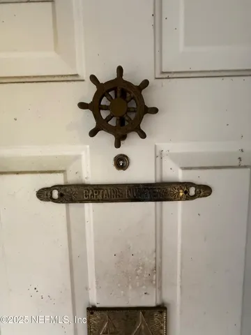 a living room with a bed and a flat screen tv
