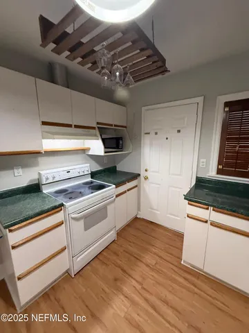 a view of a room with a table and a potted plant