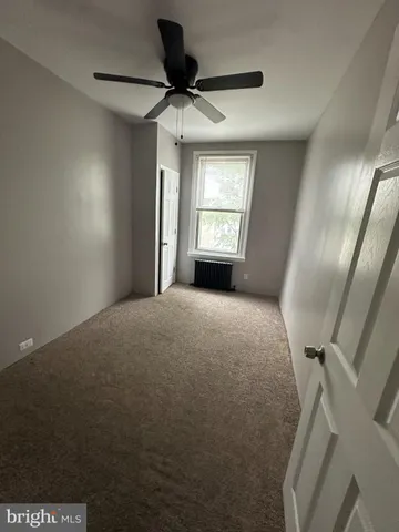 a view of an empty room and a window