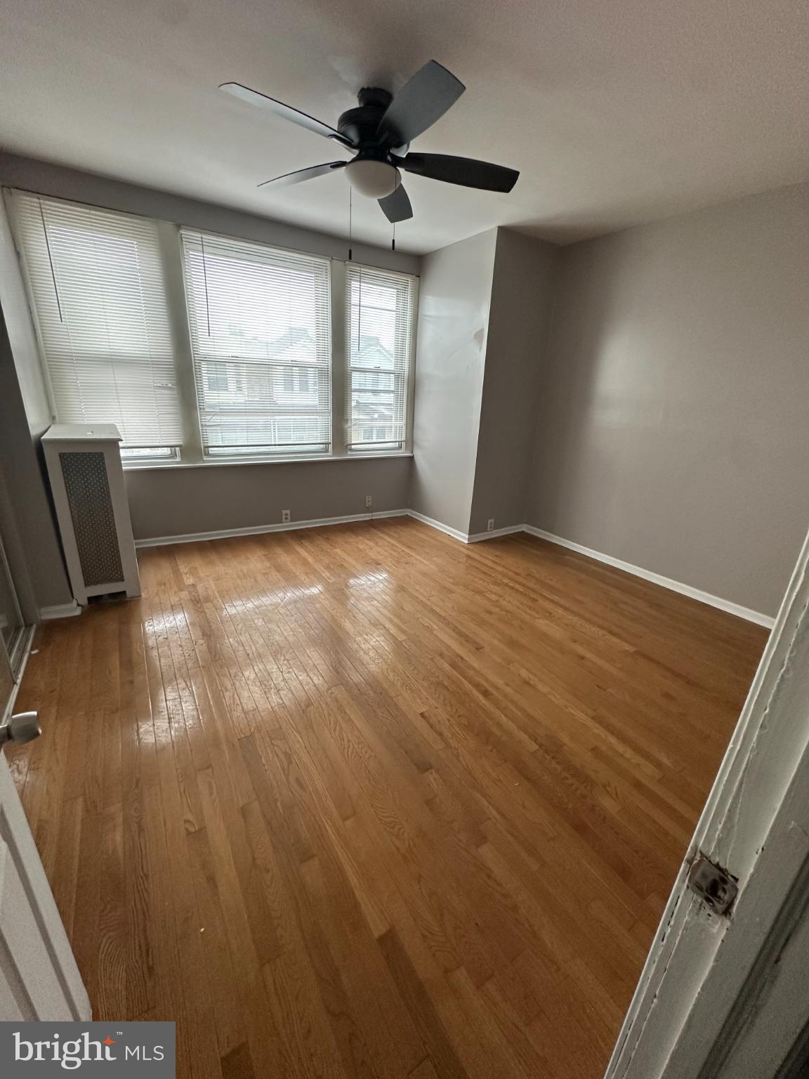 5913 Locust Street Philadelphia, PA 19139 - Photo 10 of 11 wooden floor in an empty room with a window