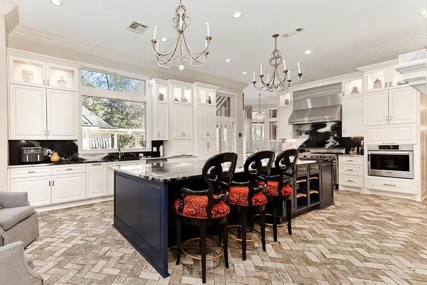 a spacious bathroom with a granite countertop sink a toilet and a mirror