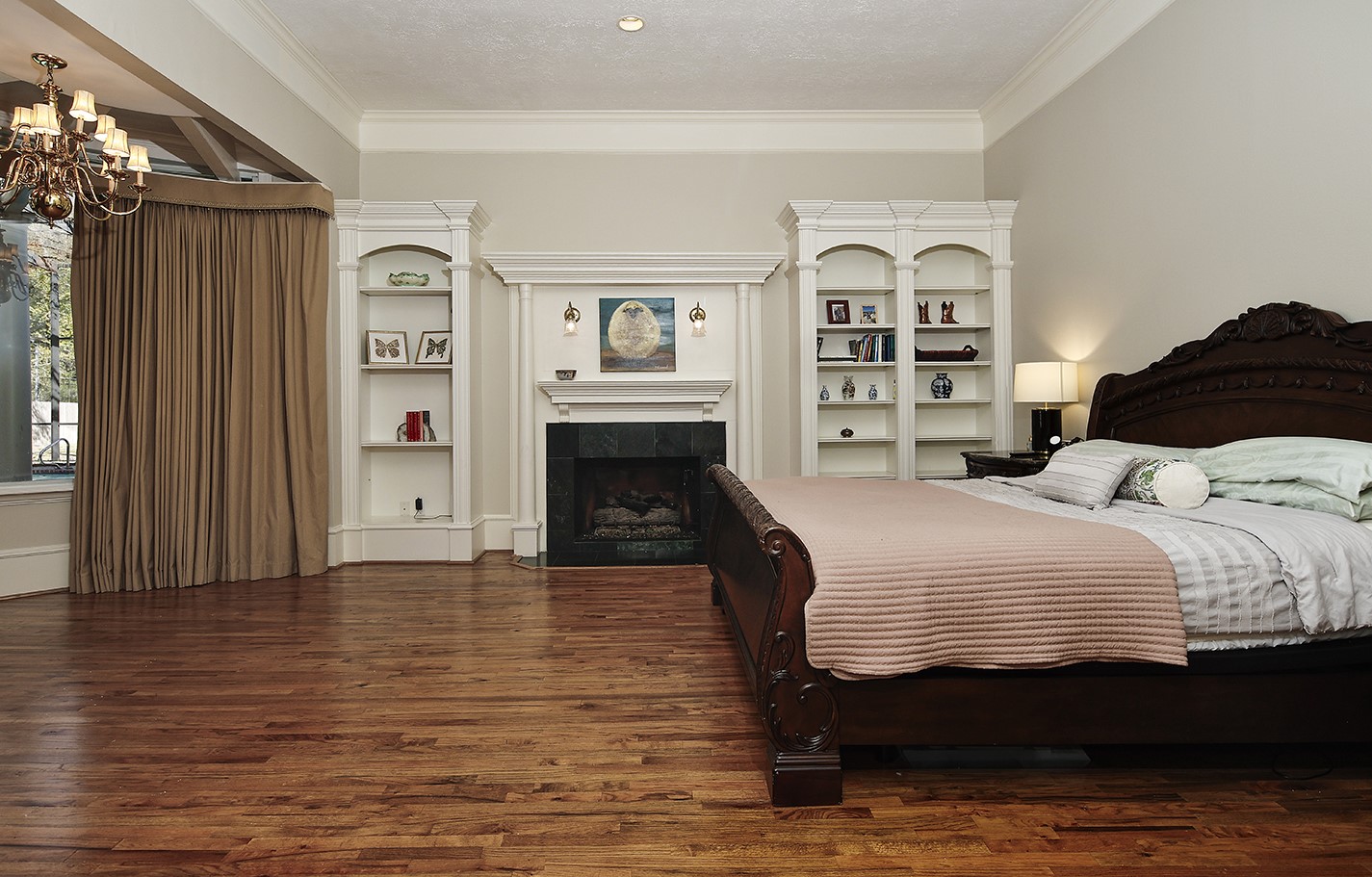 38 Grogans Point Road The Woodlands, TX 77380 - Photo 20 of 50 a bedroom with a bed and a fireplace