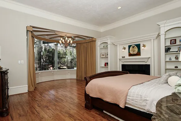 a bedroom with a bed and a television