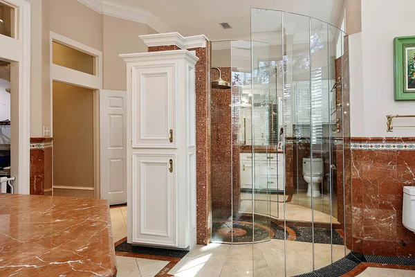 a bathroom with a sink a toilet and shower