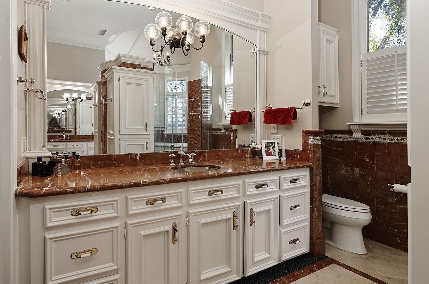 38 Grogans Point Road The Woodlands, TX 77380 - Photo 26 of 50 a spacious bathroom with a granite countertop sink a toilet and a mirror