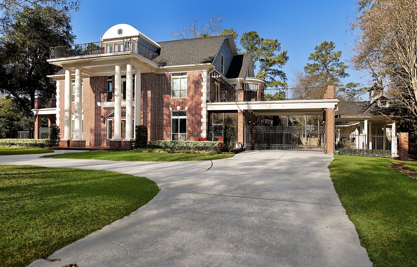 38 Grogans Point Road The Woodlands, TX 77380 - Photo 3 of 49 Gated porte-cochere leading to 3-car carriage house