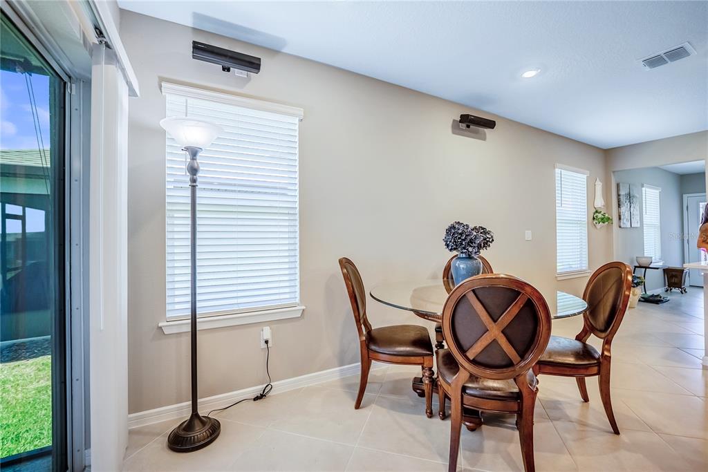 8344 Southwest 54th Loop Ocala, FL 34481 - Photo 25 of 36 a dining room with furniture and wooden floor