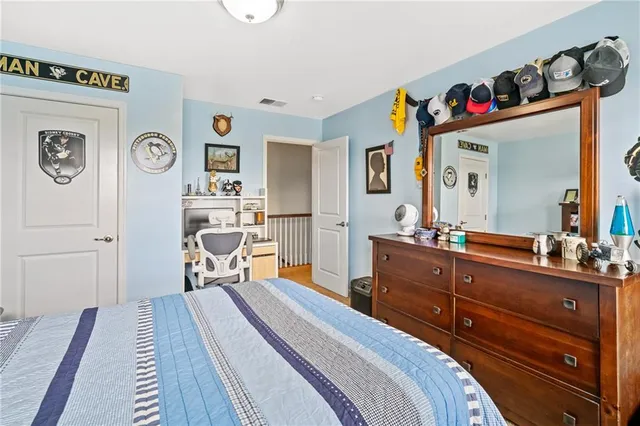 a bedroom with a bed and a dresser in it