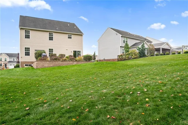 a view of a house with a yard and sitting area