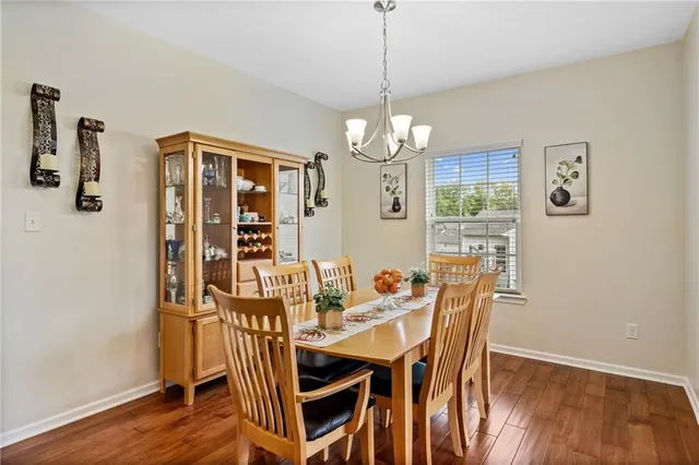 a view of a dining room with furniture wooden floor and chandelier