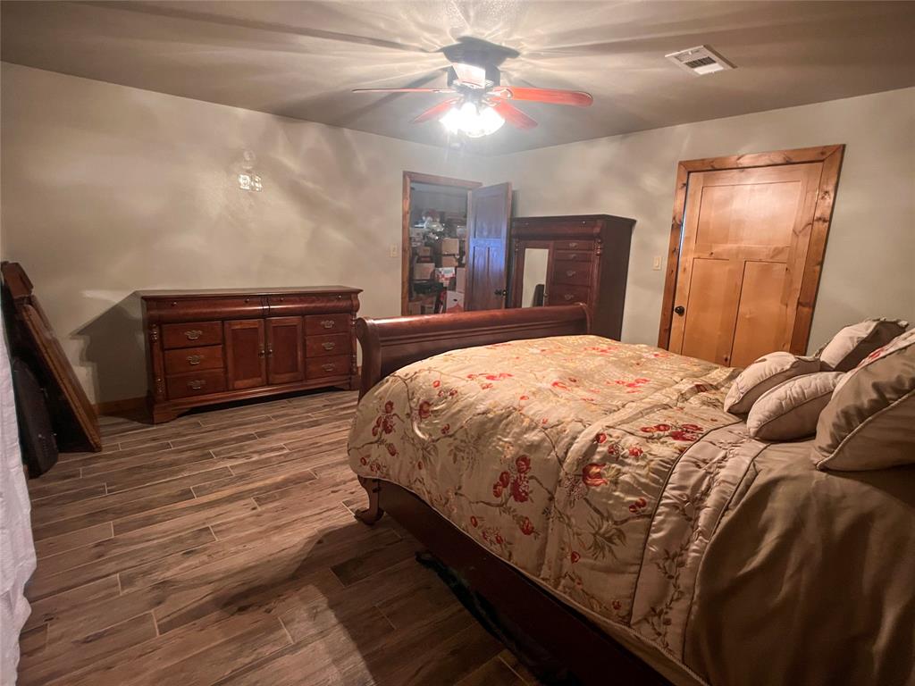 107 Private Road Whitney, TX 76692 - Photo 18 of 29 a bedroom with a large bed and a dresser