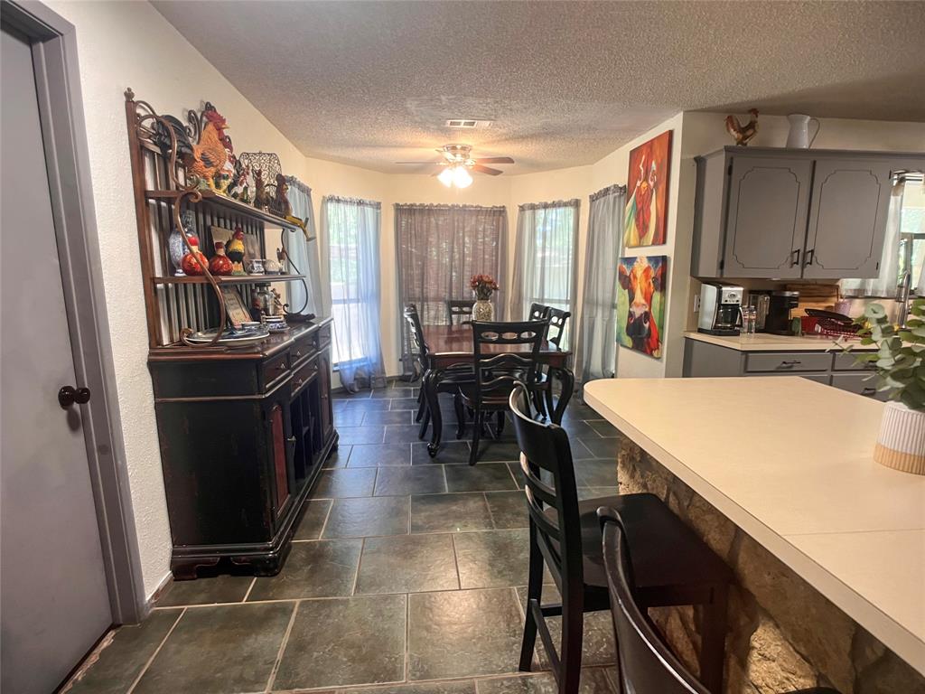 107 Private Road Whitney, TX 76692 - Photo 5 of 29 a room with stainless steel appliances a table chairs and a refrigerator