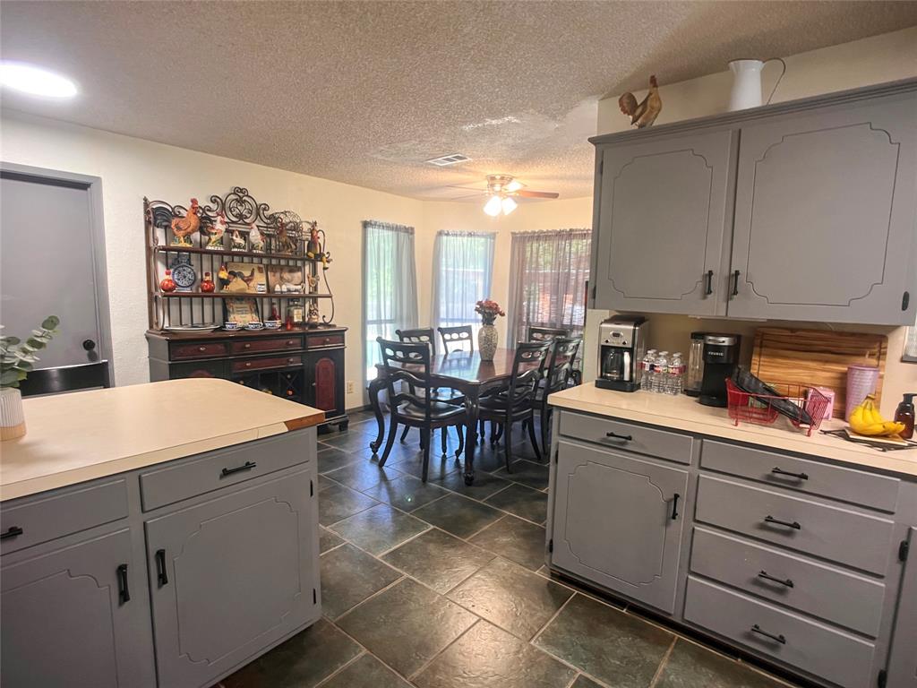 107 Private Road Whitney, TX 76692 - Photo 6 of 29 a kitchen that has a lot of cabinets in it and appliances