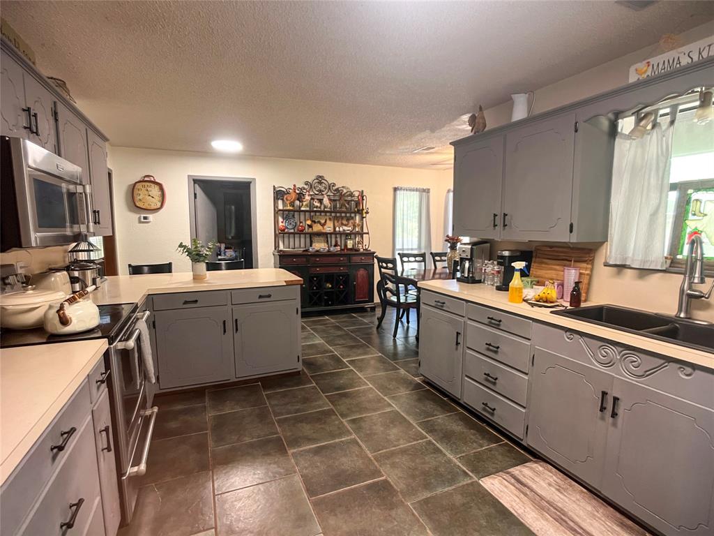 107 Private Road Whitney, TX 76692 - Photo 7 of 29 a kitchen with a sink appliances cabinets and furniture
