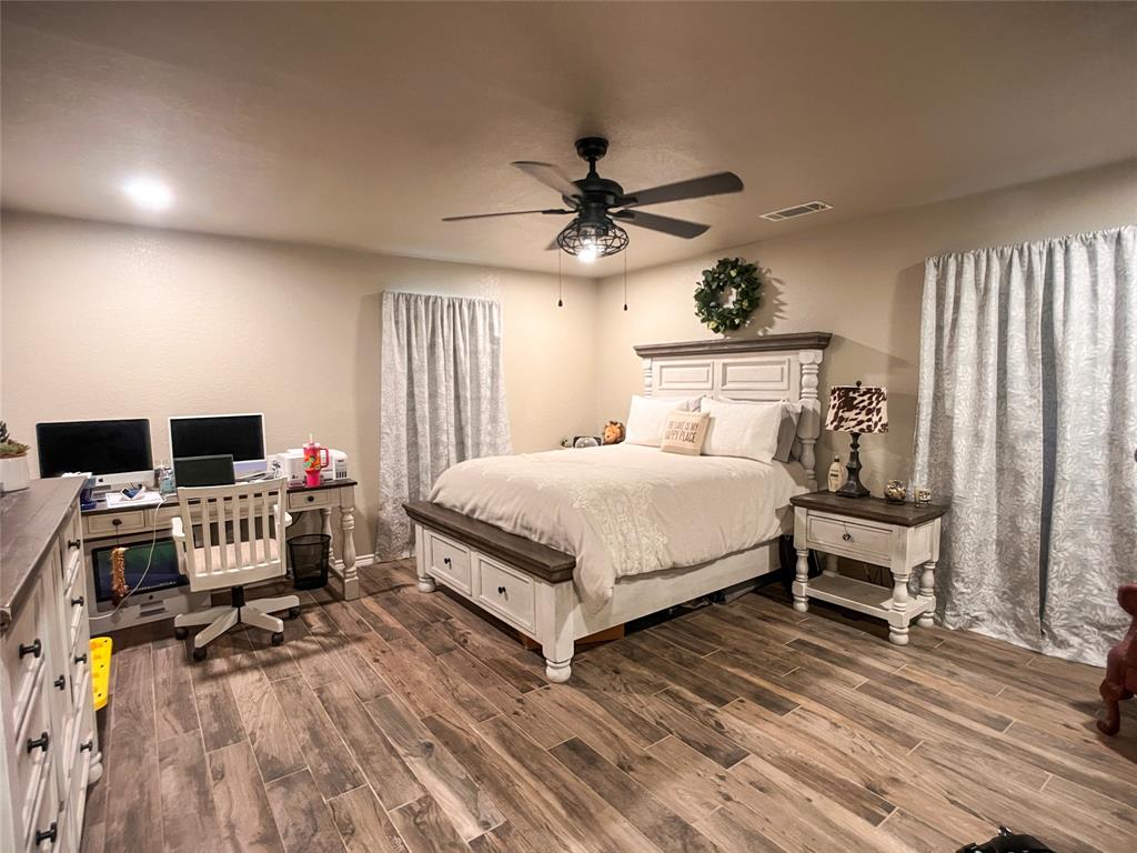 107 Private Road Whitney, TX 76692 - Photo 8 of 29 a bedroom with a bed and a desk