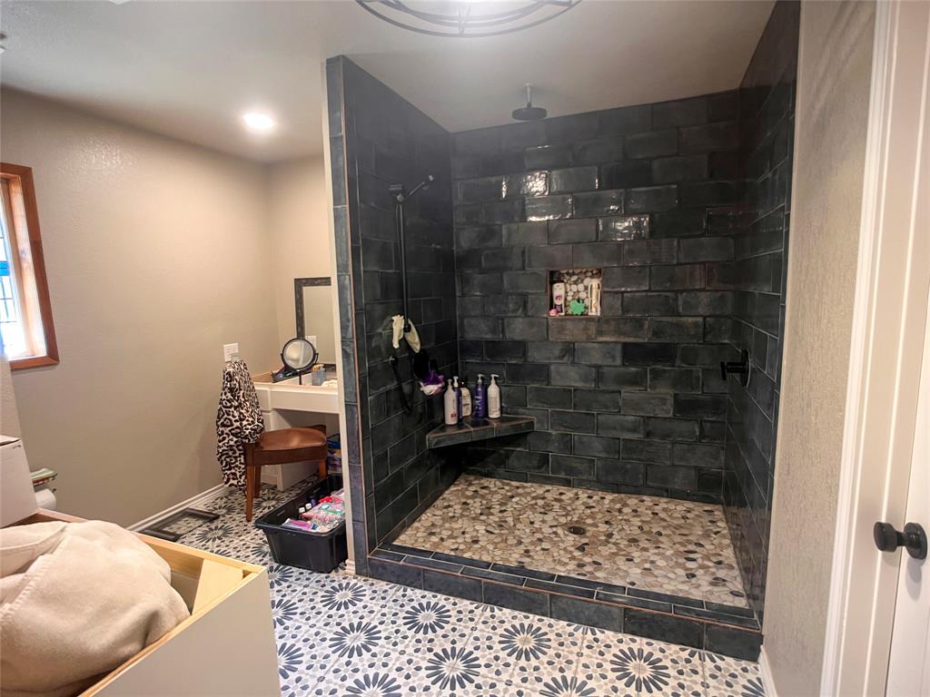 107 Private Road Whitney, TX 76692 - Photo 9 of 29 a bathroom with a glass door shower