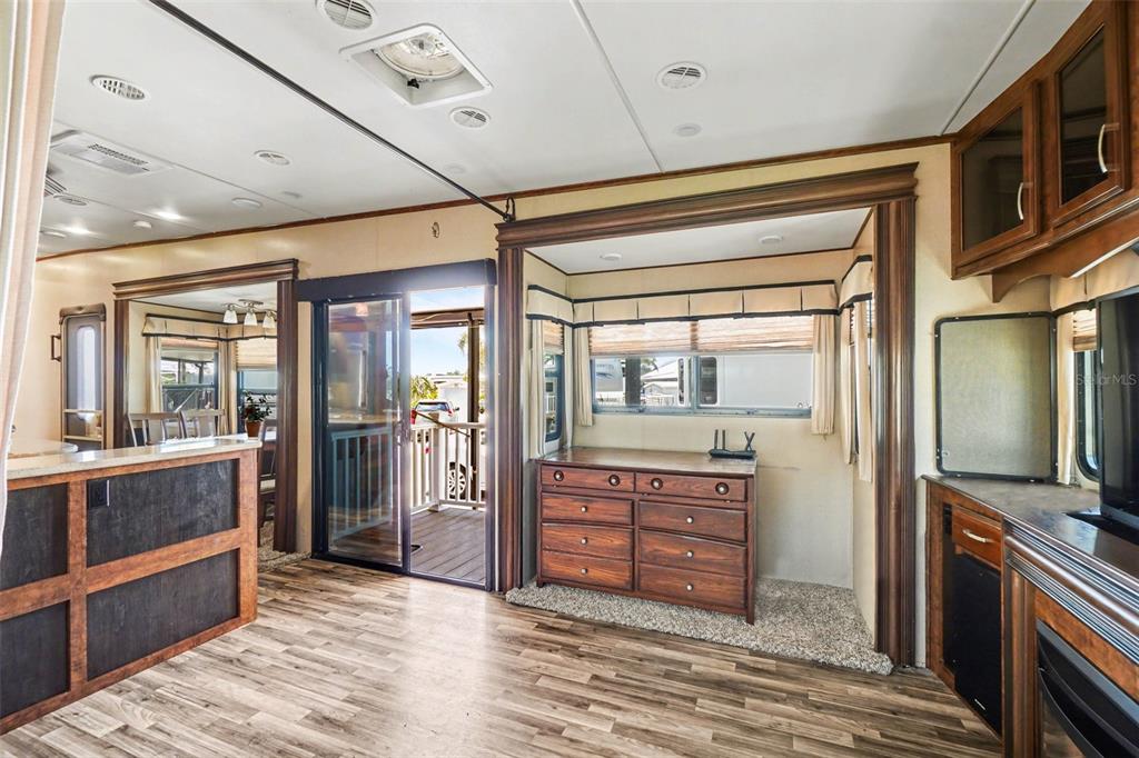 6800 Golf Course Boulevard, Unit H6 Punta Gorda, FL 33982 - Photo 5 of 15 a room with kitchen island granite countertop wooden floor and stainless steel appliances