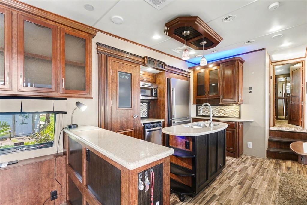 6800 Golf Course Boulevard, Unit H6 Punta Gorda, FL 33982 - Photo 8 of 15 a utility room with stainless steel appliances a stove a sink dishwasher and cabinets with wooden floor