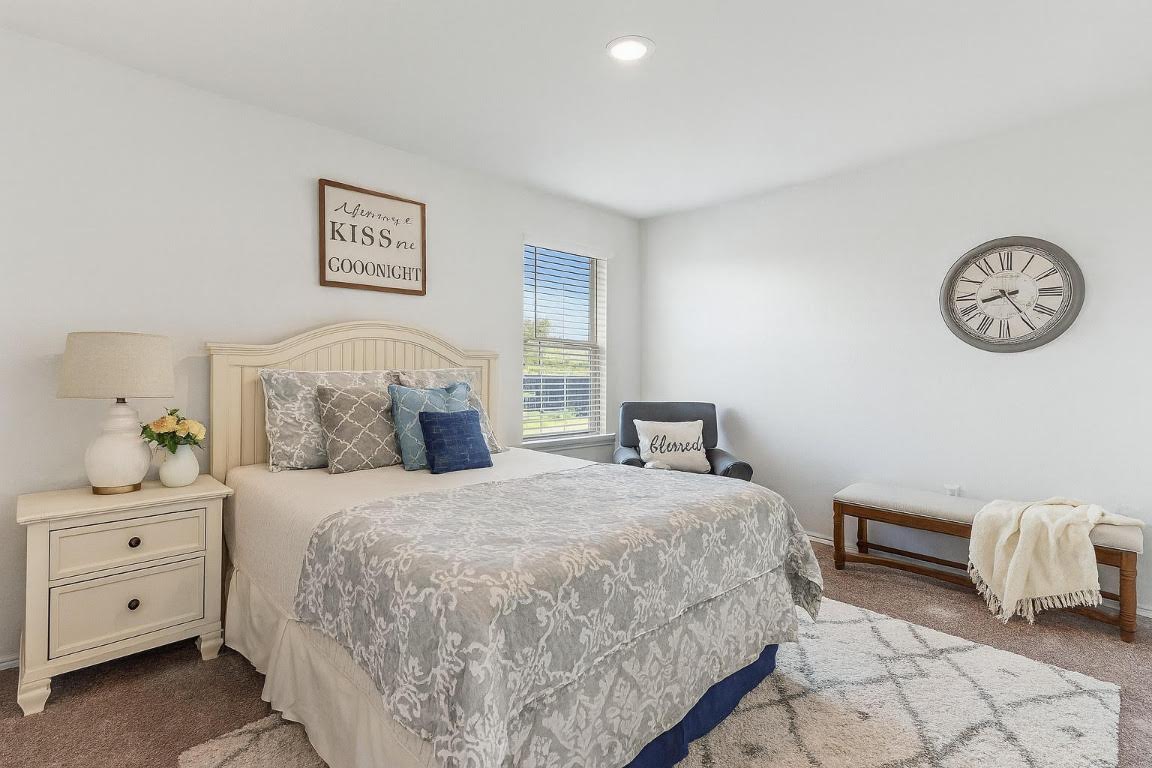 905 Duskywing Way Georgetown, TX 78626 - Photo 12 of 21 a bedroom with a bed and a lamp on dresser