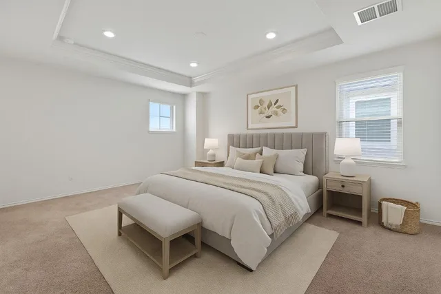 a spacious bedroom with a bed and a couch