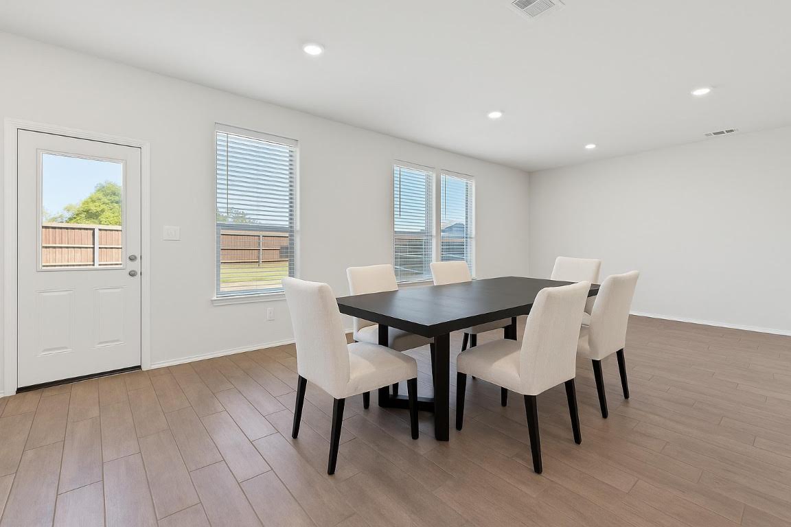 905 Duskywing Way Georgetown, TX 78626 - Photo 6 of 21 a view of a dining room with furniture and wooden floor