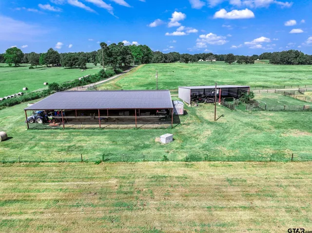a view of yard with swimming pool and green space