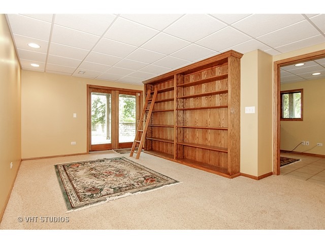 14511 Marengo Road Union, IL 60180 - Photo 11 of 25 a view of an empty room with a fireplace and a window