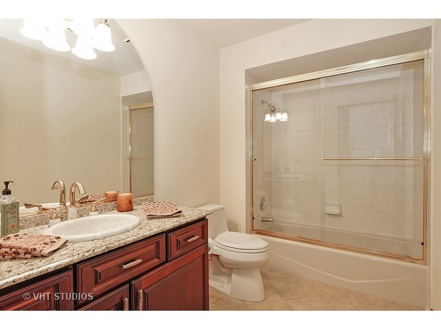14511 Marengo Road Union, IL 60180 - Photo 18 of 25 a bathroom with a granite countertop sink a toilet and shower