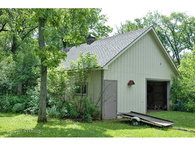 14511 Marengo Road Union, IL 60180 - Photo 23 of 25 a backyard of a house with potted plants and large tree