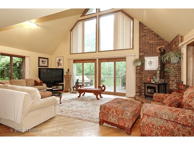14511 Marengo Road Union, IL 60180 - Photo 9 of 25 a living room with furniture a fireplace and a flat screen tv