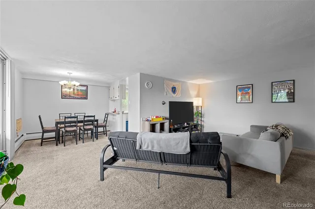 a living room with furniture a flat screen tv and a table