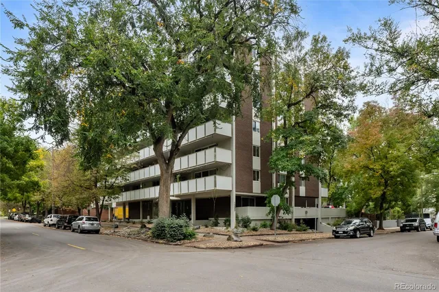 a city street lined with buildings and cars