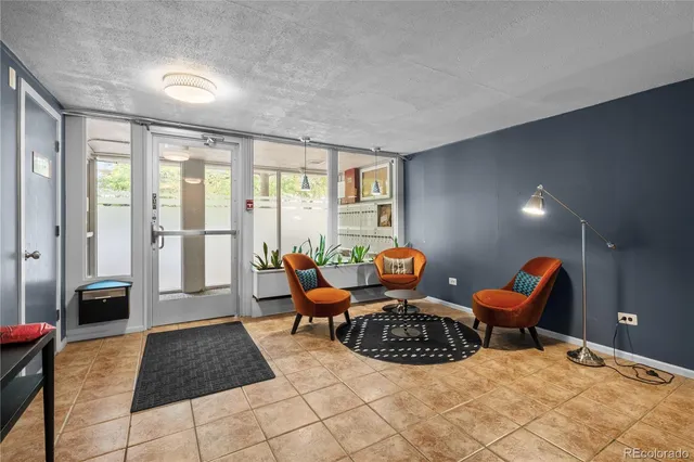 a living room with furniture a rug and a large window