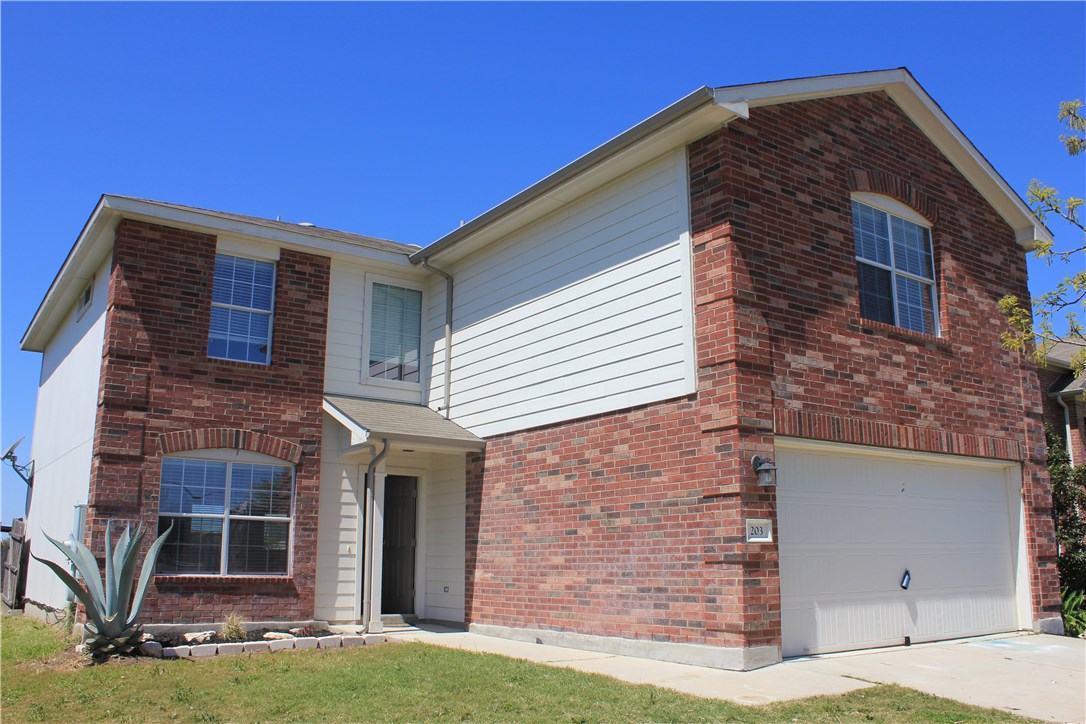 203 Wiley Street Hutto, TX 78634 - Photo 1 of 1 a front view of a house with a yard
