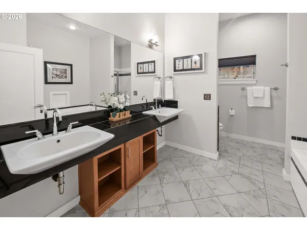 a kitchen with a sink cabinets and wooden floor